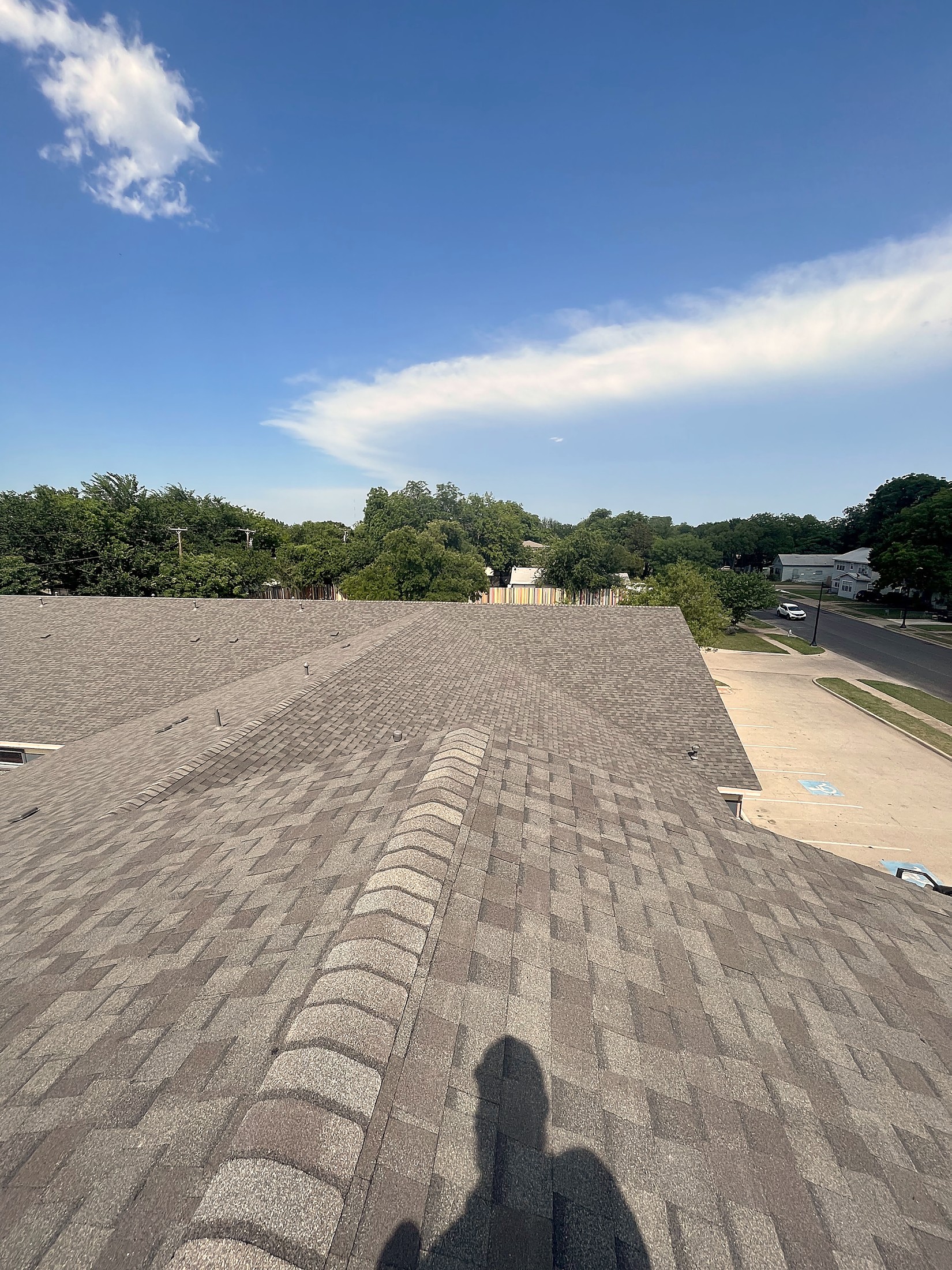 New ridge cap, a turbine vent and turtle vents on a finished gray shingle roof